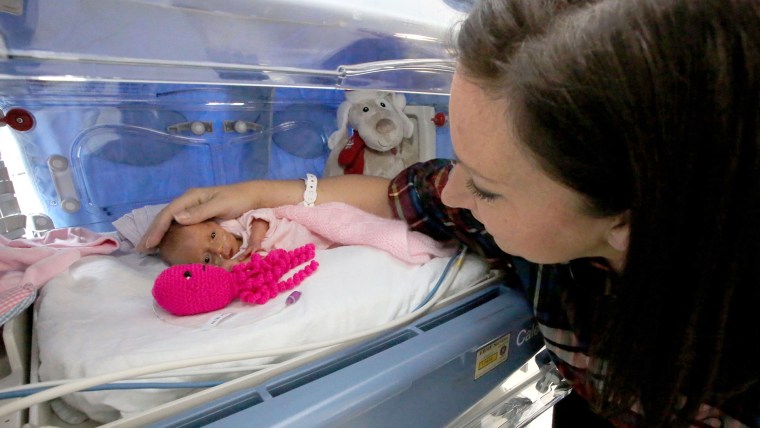 Kat with Jasmine just after she was born with her crochet octopus.