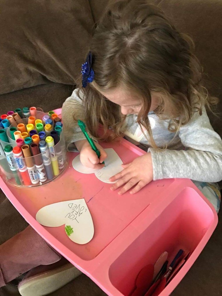 A young volunteer writes a note to refugee children for Operation Refugee Child.