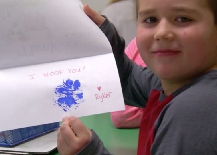 A student in Sharp's class shows off his thank you letter from Ryker.