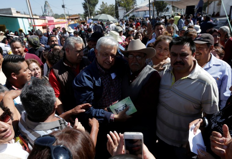 Image: MORENA party leader Obrador poses with supporters after he gave a speech in Tlapanoloya