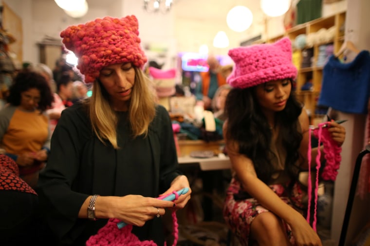 Image: Jayna Zweiman and Krista Suh take part in the Pussyhat social media campaign they created to provide pink hats for protesters in the women's march in Washington, D.C., the day after the presidential inauguration, in Los Angeles, California