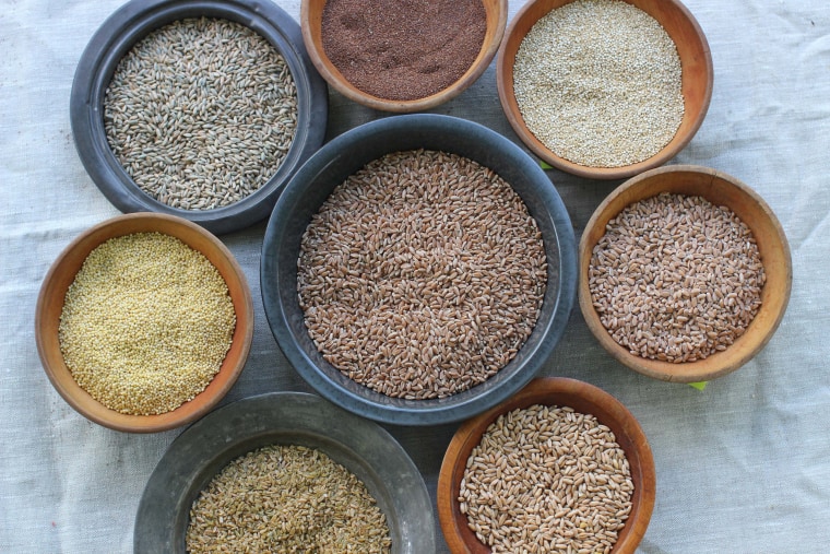 Image: Various whole grains, from top clockwise, teff, quinoa, farro triticale, freekeh, millet, rye berries and wheat berries, center, pictured in Concord, NH.