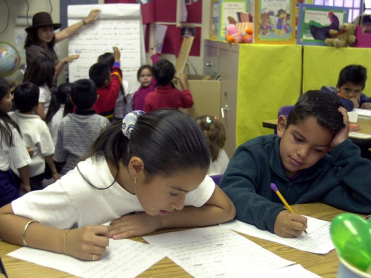 ELEMENTARY SCHOOL STUDENTS WRITE IN CLASSROOM