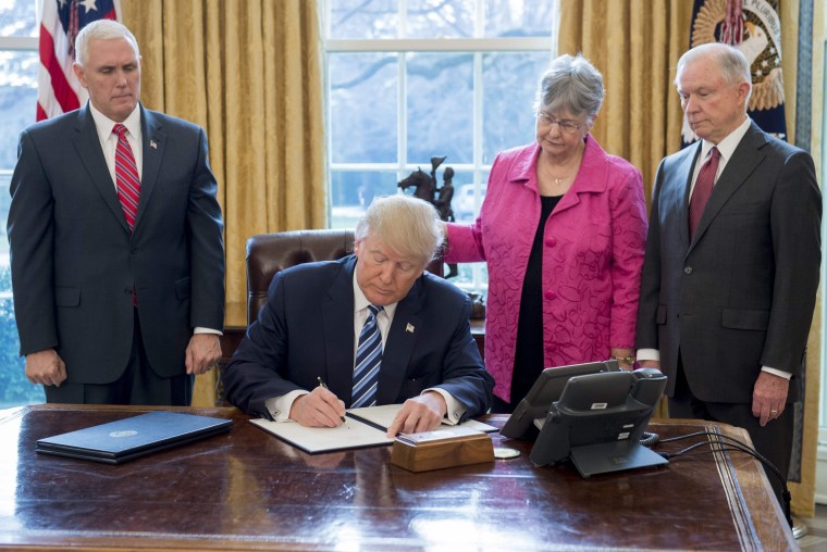Image: President Donald Trump signs an executive order related to to crime