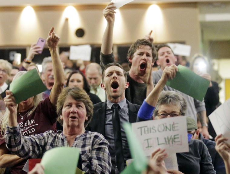 Image: People shout to Rep. Jason Chaffetz during his town hall meeting