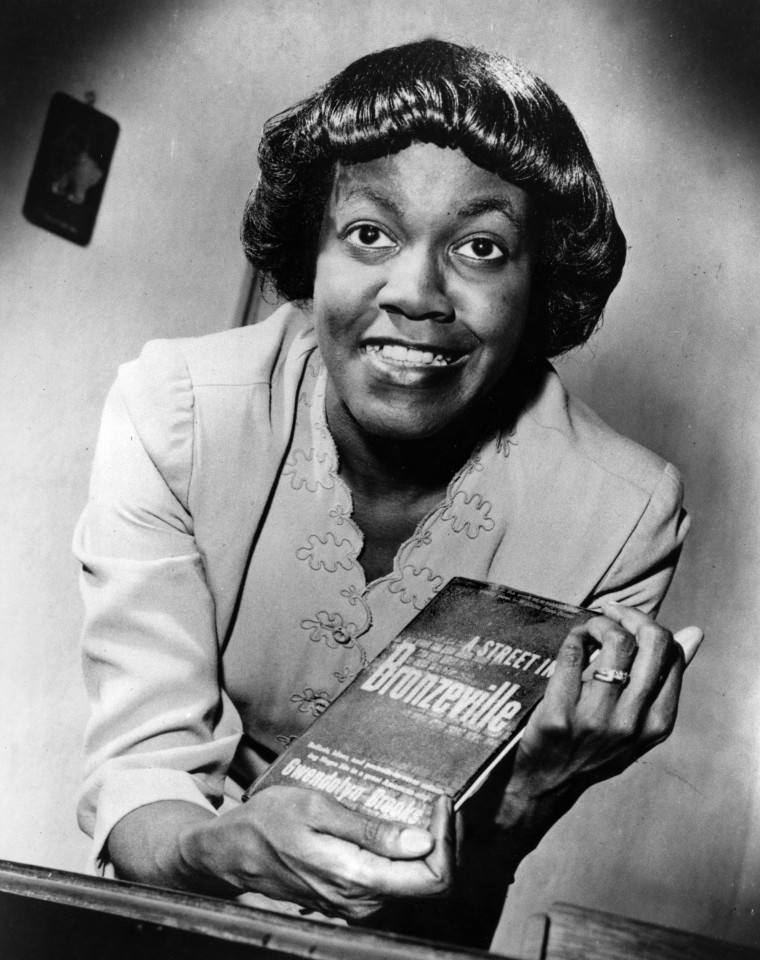 Image: American writer Gwendolyn Brooks poses with her first book of poems titled "A Street in Bronzeville," 1945, in this undated photo.