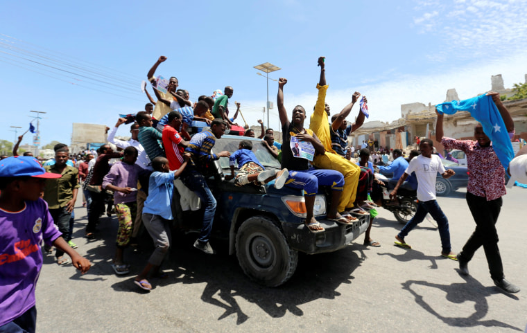 Image: Civilians ride on a police car as they celebrate the election of President Mohamed Abdullahi Mohamed, Thursday.hu