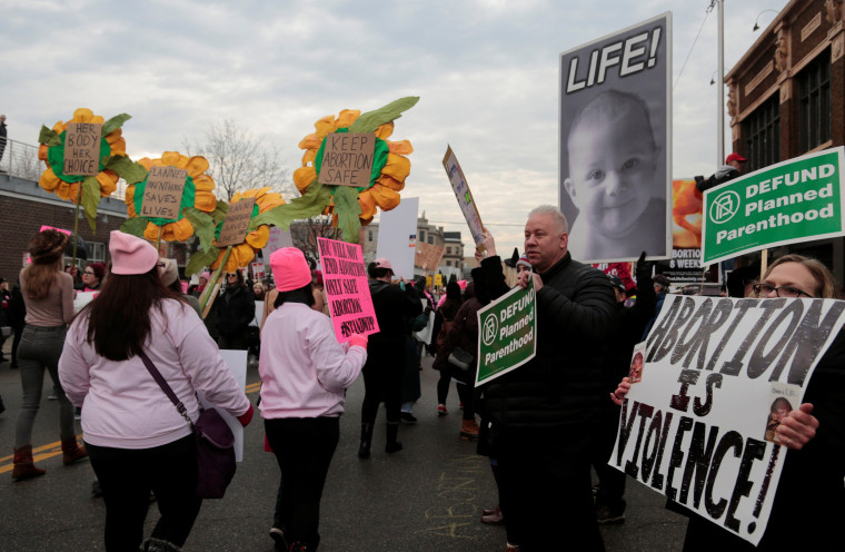 Image: Supporters of Planned Parenthood rally next to anti-abortion activists outside a Planned Parenthood clinic in Detroit, Michigan