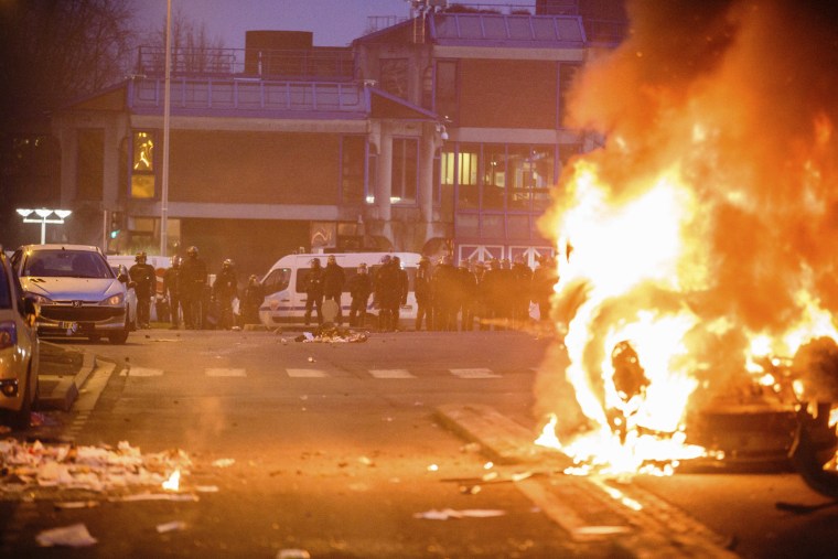 Image: Police face protesters as a car burns in Bobigny, Paris, Saturday.