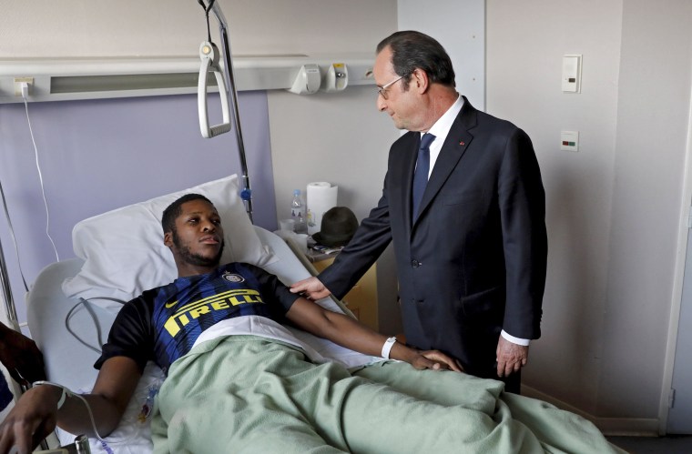 Image: A handout photo from French newspaper Le Parisen shows President Francois Hollande visiting 'Theo' in hospital.
