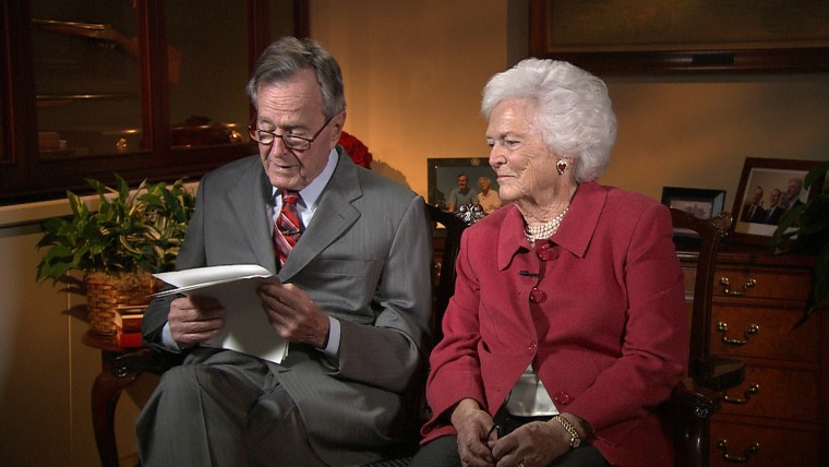 George H. W. Bush and Barbara Bush reading letters