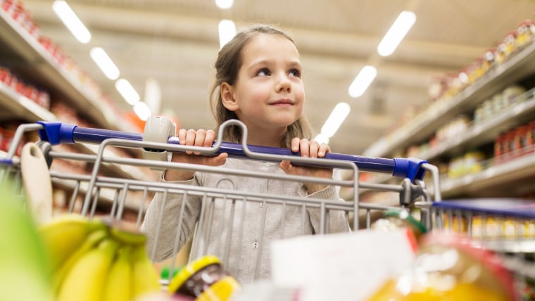 Little girl pushing shopping cart