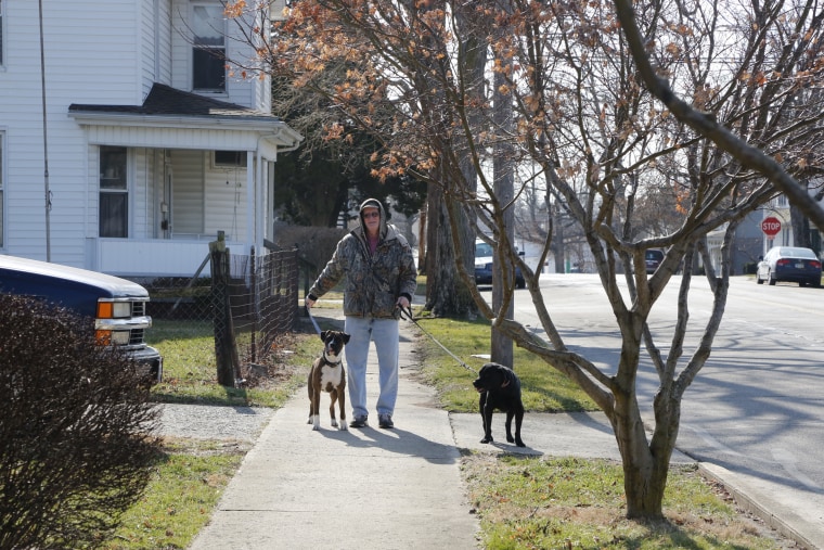 Image: A Circleville resident walks through the old manufacturing community, where a drop in blue-collar jobs has left residents seeking a rejuvenation under President Trump.