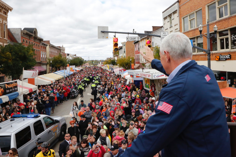 Image: Mike Pence, then-vice presidential candidate, waves to thousands at the annual Circleville Pumpkin Show on October 22, making the pit stop through the Ohio town that ultimately swung overwhelming Republican and helped the ticket win the state on El