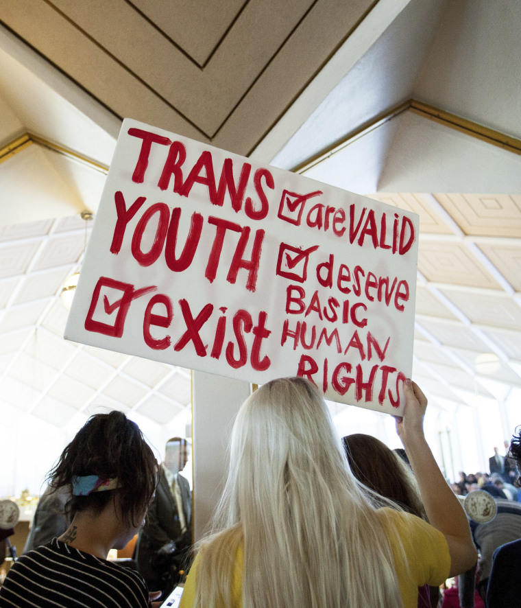Image: Hunter Schafer, of Raleigh, holds a sign in favor of repealing North Carolina HB2 during a special session of the North Carolina General Assembly in Raleigh, N.C. on Dec. 21, 2016.
