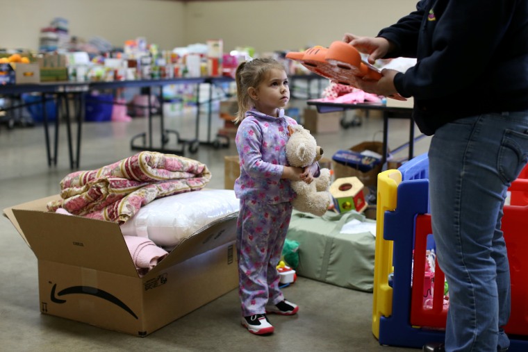Image: Emma Neurohr, 4, of Oroville, watches her mother at the Salvation Army relief center at the Placer County Fairgrounds in Roseville, California, after an evacuation was ordered for communities downstream from the dam in Oroville