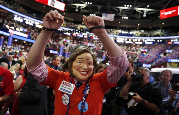 Delegate wears a mask of Democratic presidential candidate Clinton before the start of the final day of the Republican National Convention in Cleveland