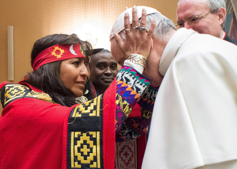Image: A woman holds Pope Francis' head on the occasion of his meeting with representatives of indigenous peoples attending a UN agricultural meeting in Rome, at the Vatican, Feb. 15, 2017.