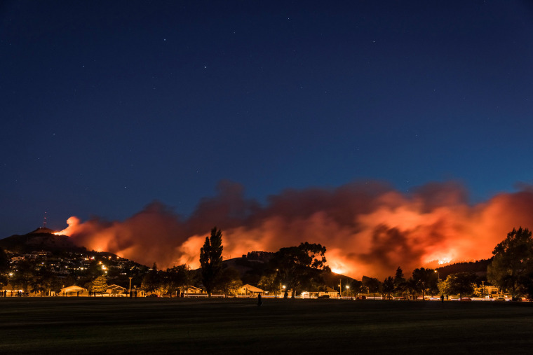 Image: Wildfires threaten a suburb of Christchurch on New Zealand's South Island taken after sunset