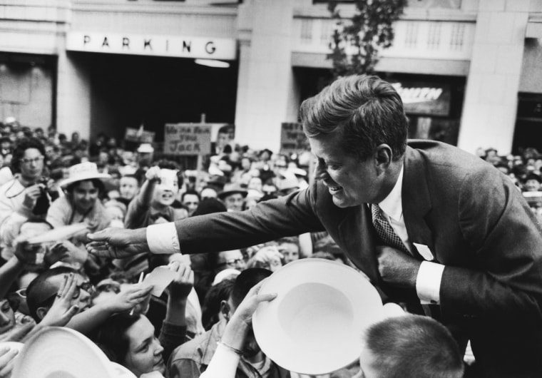 Image: Massachusetts Senator John F. Kennedy shakes hands with a crowd in Seattle