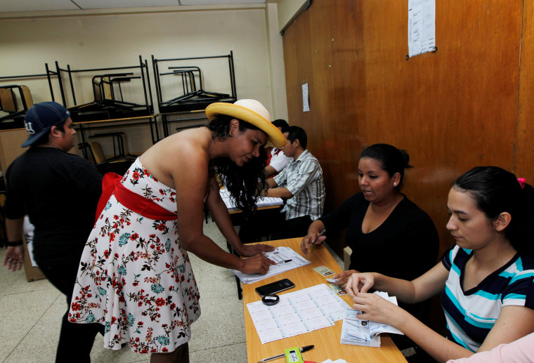 Image: Diane Rodriguez, a member of the Ecuadorean transgender community, registers before casting her vote during the presidential election in Guayaquil