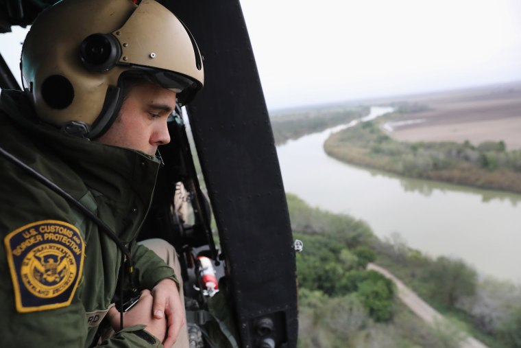 Image: A U.S. Customs and Border Protection helicopter crew searches for illegal immigrants