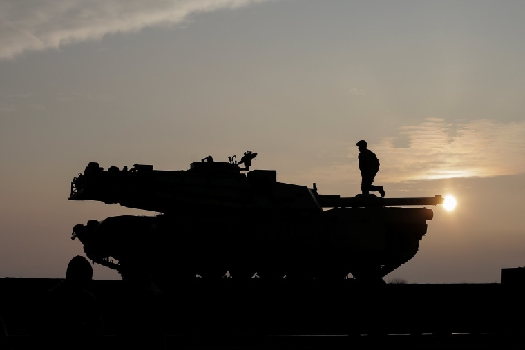 Image: US soldiers prepare a M1 Abrams tank to offload from a train at the Mihail Kogalniceanu Air Base