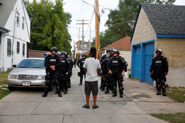 Image: Police in riot gear assemble in an alley after disturbances following the police shooting of a man in Milwaukee, Wisconsin, Aug. 15, 2016.