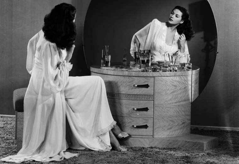 Image: Portrait of actress Yvonne De Carlo brushing her hair in the mirror of a vanity table, for Universal Pictures, 1945.