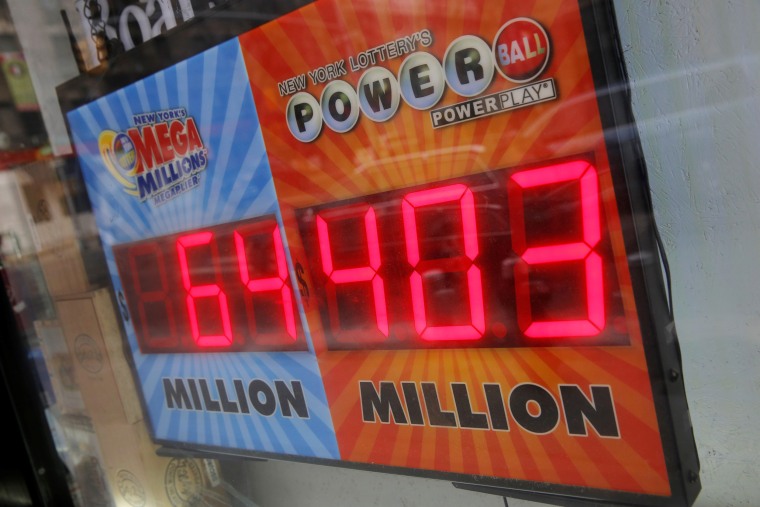 Image: A sign advertises the U.S. lottery Powerball jackpot outside a store on Kenmare Street in Manhattan, New York