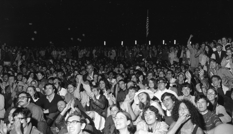 Image: An estimated 10,000 people gathered to watch giant television screens in New York's Central Park and cheer as astronaut Neil Armstrong took man's first step on the moon on July 20, 1969.