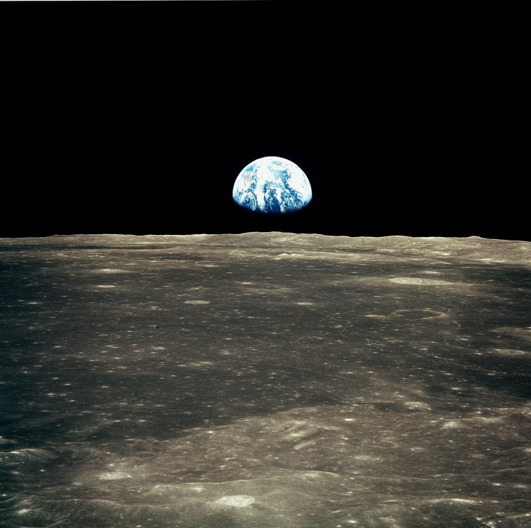 Image: This view from the Apollo 11 spacecraft shows Earth rising above the moon's horizon