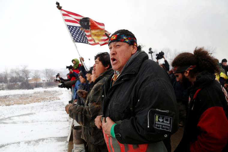 Image: Raymond Kingfisher of the Northern Cheyenne Tribe sings during a march on the outskirts of the main opposition camp against the Dakota Access oil pipeline near Cannon Ball