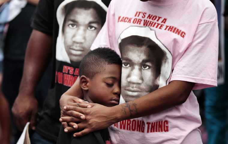 Image: LeTasha Brown stands with her arms around Anthony Dixon Jr. during an NAACP march and rally to the front of the Sanford Police Department for Trayvon Martin in Sanford, Florida, March 31, 2012.