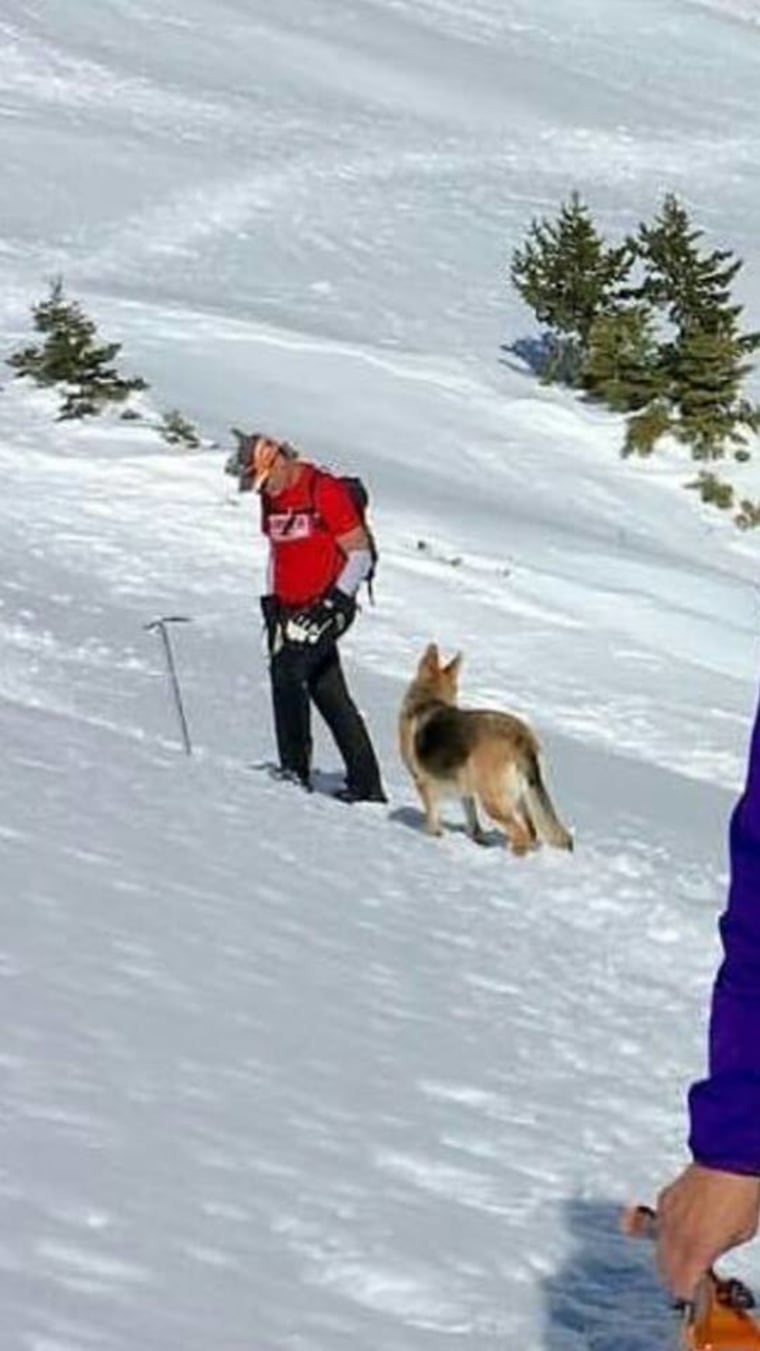 Warren Muldoon and Dakota the dog hike together in the snow.