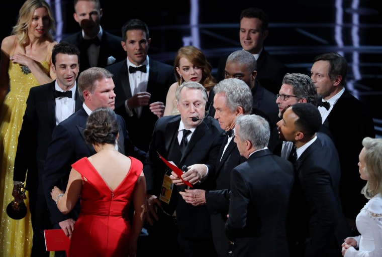 Image: Warren Beatty holds the card for the best picture winner on stage during the confusion