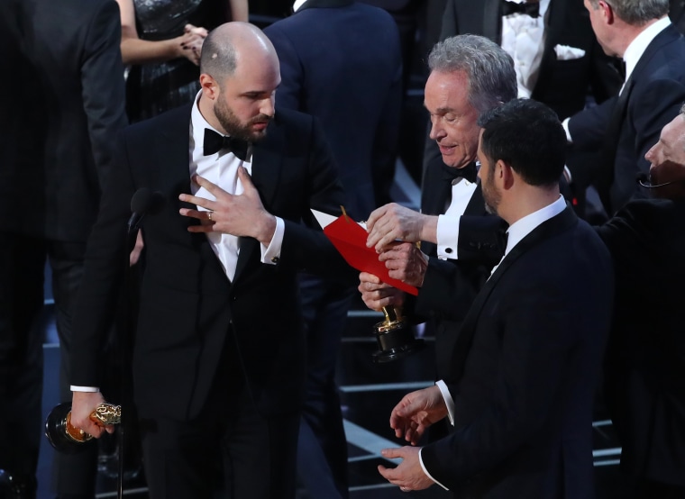 Image: Jordan Horowitz of \"La La Land\" speaks with award presenter Warren Beatty and show host Jimmy Kimmel