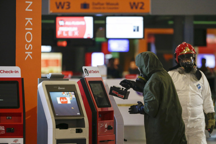 Image: A hazmat team conducts checks in Kuala Lumpur International Airport 