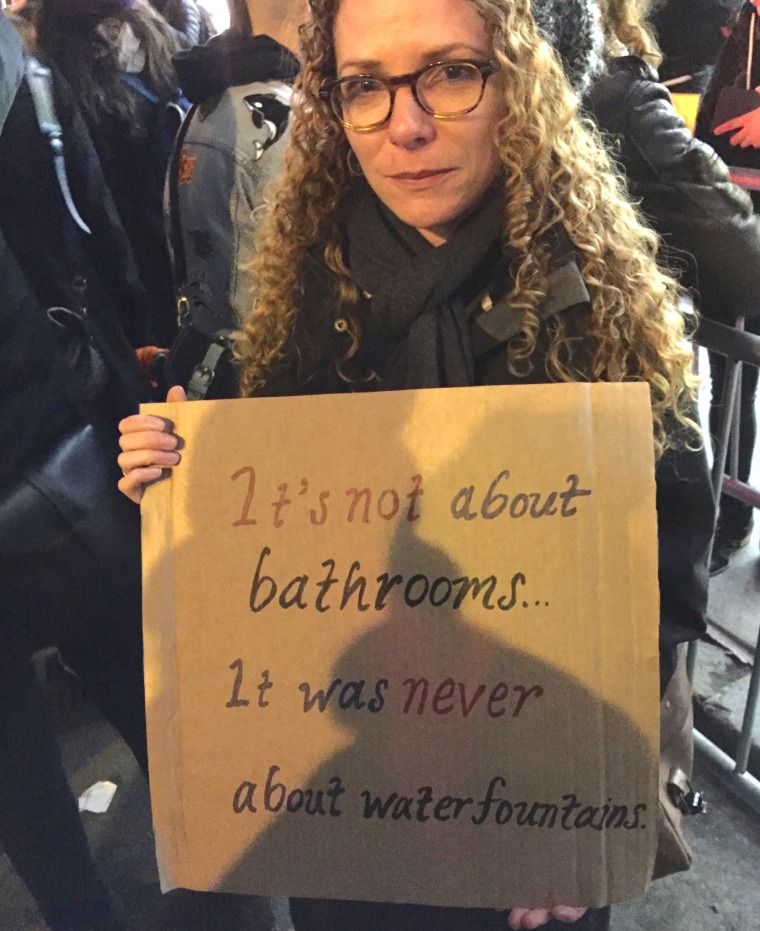 Protester Jackie MacLeod holds up a sign at the "Queer and Trans Dance Party/Protest" in front of Trump Tower on Feb. 26, 2017
