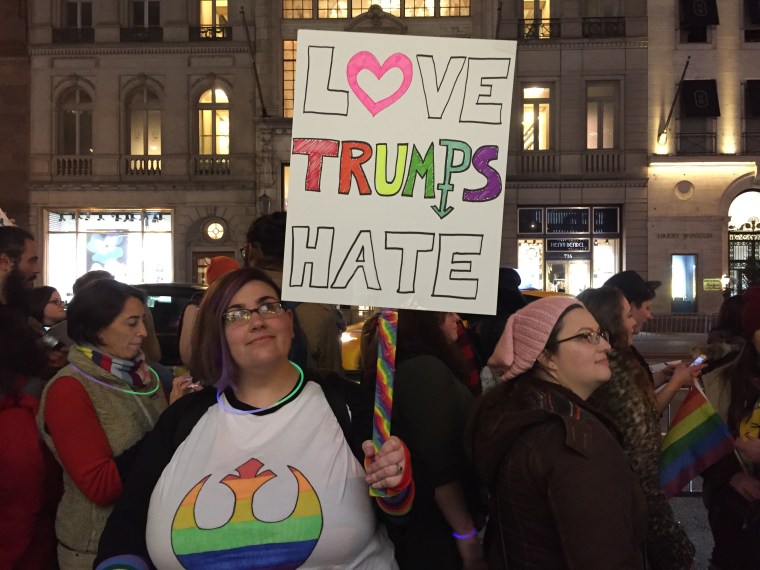 Mel, a protester, holds up a sign at the "Queer and Trans Dance Party/Protest" in front of Trump Tower in NYC on Feb. 26, 2017