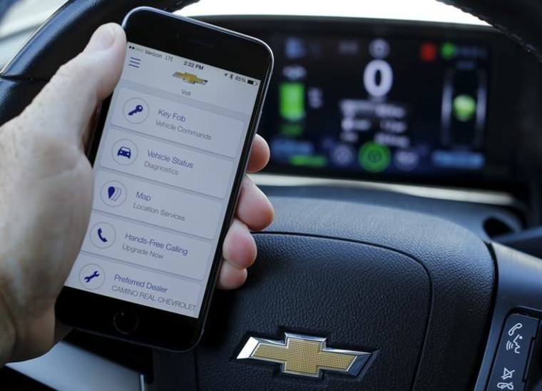A mobile phone displays the OnStar app inside a Chevrolet Volt vehicle in this photo illustration taken in Encinitas