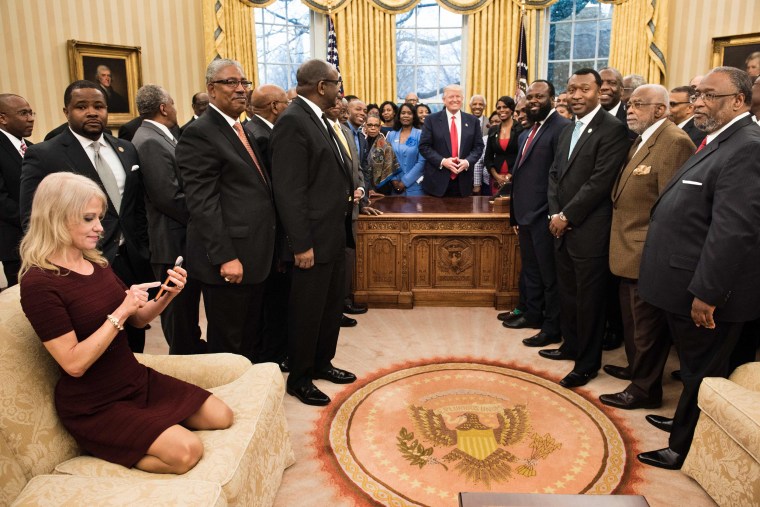 Image: Kellyanne Conway checks her phone after taking a photo