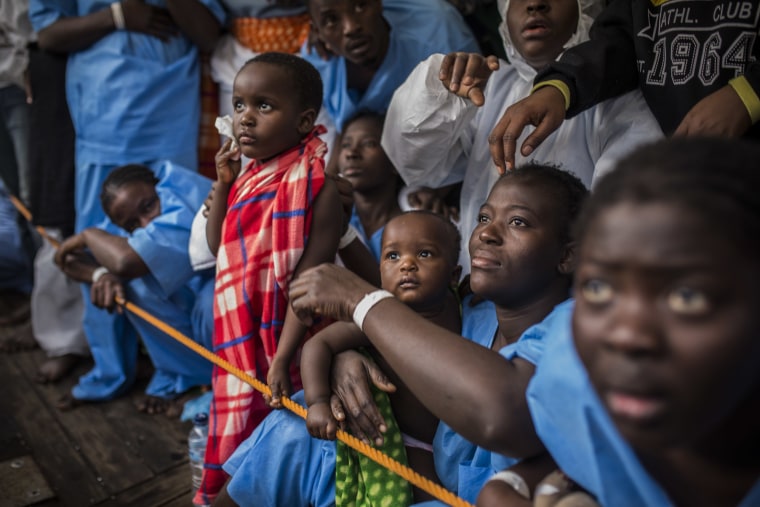 Image: African refugees and migrants wait aboard the Golfo Azurro to disembark