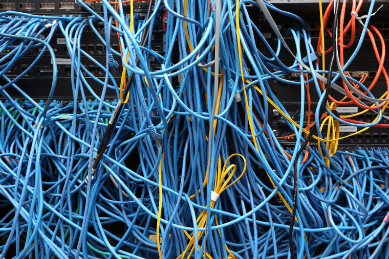 Image: Network cables are plugged in a server room