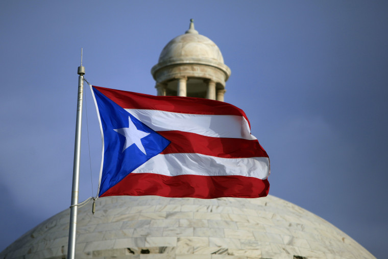 FILE - In this July 29, 2015 file photo, the Puerto Rican flag flies in front of Puerto Rico's Capitol as in San Juan, Puerto Rico.