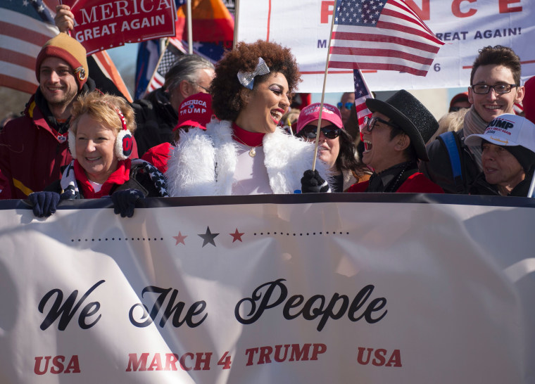 Image: Singer Joy Villa, center, and designer Andre Soriano take part in a pro-Trump rally outside the Washington Monument on March 4, 2017, in Washington, DC.