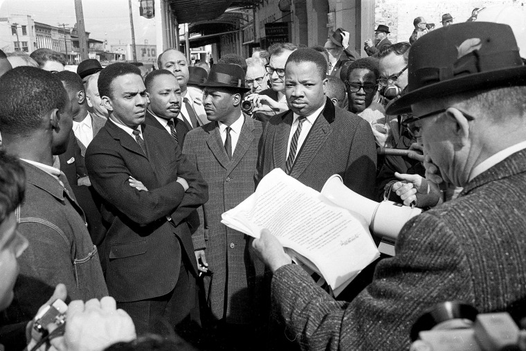 Image: A federal marshal reads a court order halting a planned voter registration protest march at Selma, Alabama, March 9, 1965.