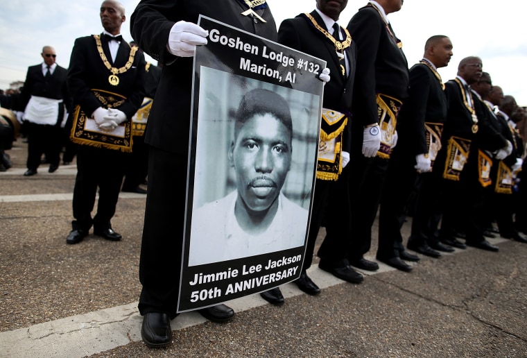 Image: A marcher holds a poster of Jimmie Lee Jackson, a civil rights activist who was beaten and shot by Alabama State troopers in 1965, during the 50th anniversary commemoration of the Selma to Montgomery civil rights march on March 8, 2015 in Selma.