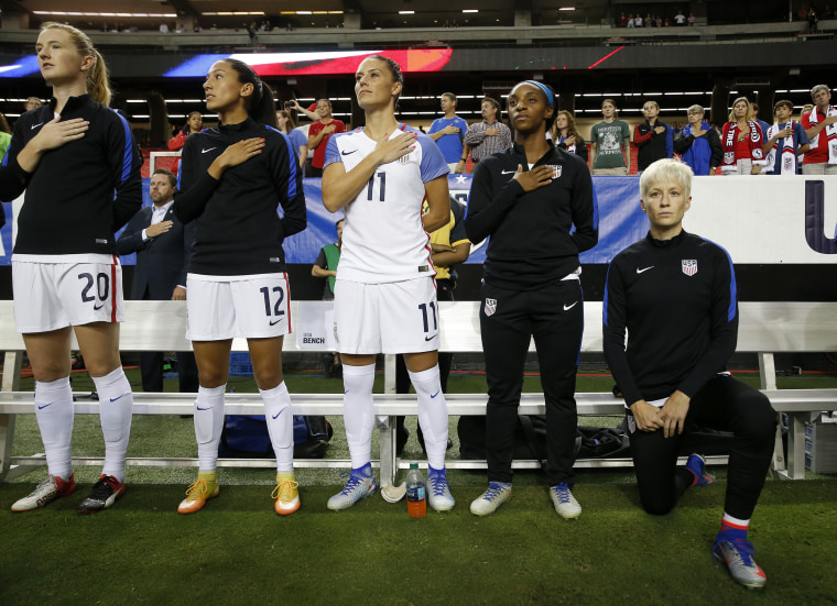 Image: USA's Megan Rapinoe, right, kneels next to teammates Samanth Mewis, Christen Press, Ali Krieger, Crystal Dunn and Ashlyn Harris as the U.S. national anthem is played before an exhibition soccer match against Netherlands, Sept. 18, 2016, in Atlanta.