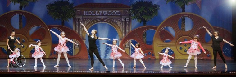 Volunteers help student dancers during A Chance to Dance stage performance